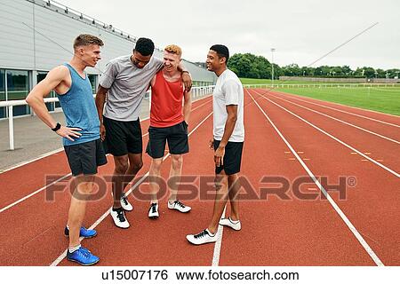 Friends talking on running track View Large Photo Image Stock Photograph - Friends talking on running track. Fotosearch