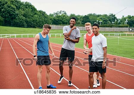 Stock Photography - Friends talking on running track. Fotosearch