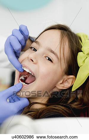 Girl at orthodontist View Large Photo Image Stock Photograph - Girl at orthodontist. Fotosearch