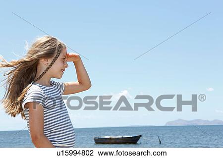 Girl with long blond hair looking out from beach, Trapani, Sicily, Italy View Large Photo Image Stock Image - Girl with long blond hair looking out from beach, Trapani, Sicily, Italy. Fotosearch