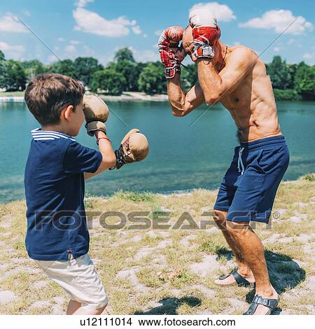 Picture - Grandfather and grandson boxing. Fotosearch