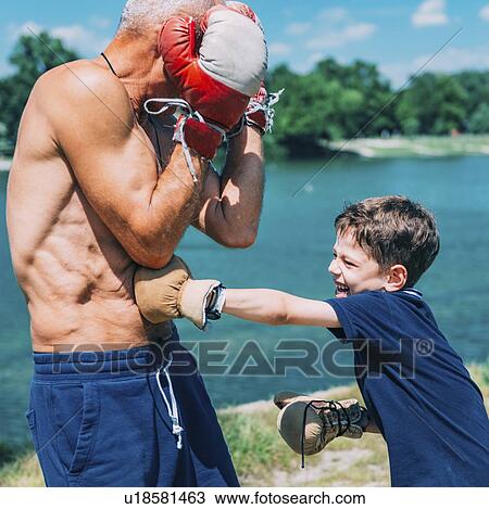Stock Image - Grandfather and grandson boxing. Fotosearch