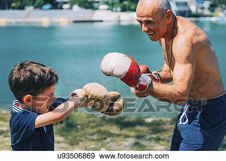 Stock Photo - Grandfather and grandson boxing. Fotosearch
