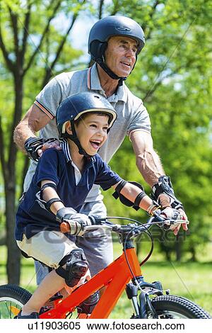 Stock Photography - Grandfather and grandson having fun in the park. Fotosearch