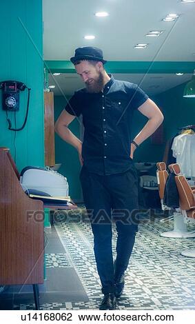 Happy barber beside cash till View Large Photo Image Stock Image - Happy barber beside cash till. Fotosearch