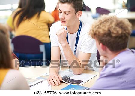 Stock Photograph - Higher education students working on project in college classroom. Fotosearch