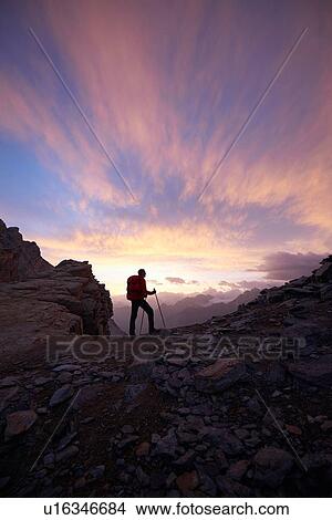 Picture - Hiker admiring sunset, Mont Cervin, Matterhorn, Valais, Switzerland. Fotosearch