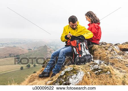 Stock Image - Hiker couple resting, Chrome Hill, Peak District, Derbyshire. Fotosearch
