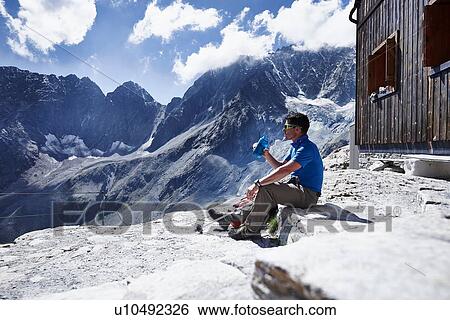 Hiker drinking from water bottle, Mont Cervin, Matterhorn, Valais, Switzerland View Large Photo Image Stock Photograph - Hiker drinking from water bottle, Mont Cervin, Matterhorn, Valais, Switzerland. Fotosearch