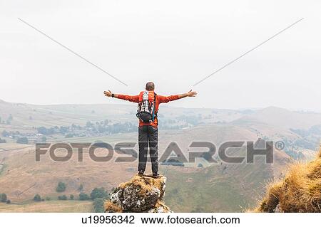 Stock Image - Hiker enjoying view from summit, Chrome Hill, Peak District, Derbyshire. Fotosearch