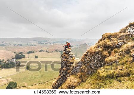 Stock Photo - Hiker enjoying view from summit, Chrome Hill, Peak District, Derbyshire. Fotosearch