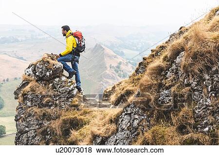 Stock Photo - Hiker enjoying view from summit, Chrome Hill, Peak District, Derbyshire. Fotosearch