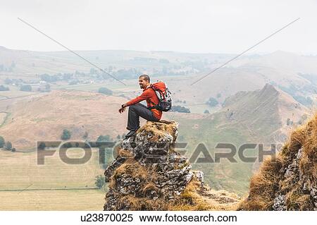 Stock Photography - Hiker enjoying view from summit, Chrome Hill, Peak District, Derbyshire. Fotosearch