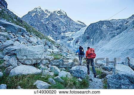 Stock Image - Hiker friends in Mont Cervin, Matterhorn, Valais, Switzerland. Fotosearch