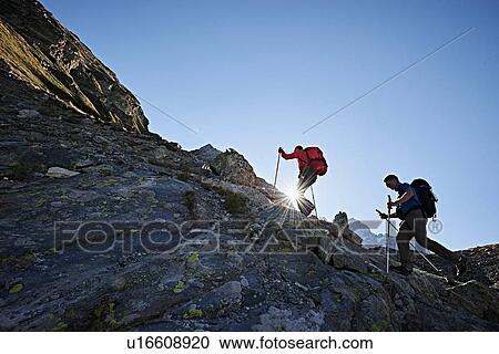 Stock Image - Hiker friends in Mont Cervin, Matterhorn, Valais, Switzerland. Fotosearch