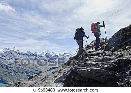 Stock Image - Hiker friends in Mont Cervin, Matterhorn, Valais, Switzerland. Fotosearch