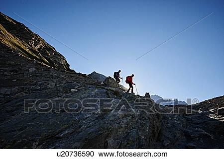 Stock Image - Hiker friends in Mont Cervin, Matterhorn, Valais, Switzerland. Fotosearch