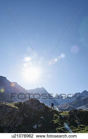Stock Image - Hiker going up to peak of rock, Mont Cervin, Matterhorn, Valais, Switzerland. Fotosearch