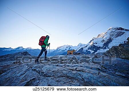Stock Photo - Hiker on rocky surface, Mont Cervin, Matterhorn, Valais, Switzerland. Fotosearch