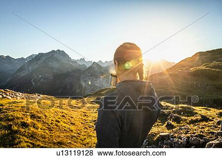 Hiker taking break with warm drink, Karwendel region, Hinterriss, Tirol, Austria View Large Photo Image Stock Photo - Hiker taking break with warm drink, Karwendel region, Hinterriss, Tirol, Austria. Fotosearch