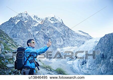 Hiker taking photograph, Mont Cervin, Matterhorn, Valais, Switzerland View Large Photo Image Stock Photography - Hiker taking photograph, Mont Cervin, Matterhorn, Valais, Switzerland. Fotosearch