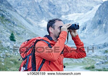 Stock Photo - Hiker using binoculars, Mont Cervin, Matterhorn, Valais, Switzerland. Fotosearch