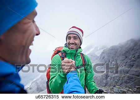 Stock Photography - Hikers congratulating themselves, Mont Cervin, Matterhorn, Valais, Switzerland. Fotosearch