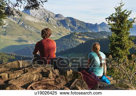 Stock Photography - Hikers enjoying view of mountains, Manigod, Rhone-Alpes, France. Fotosearch