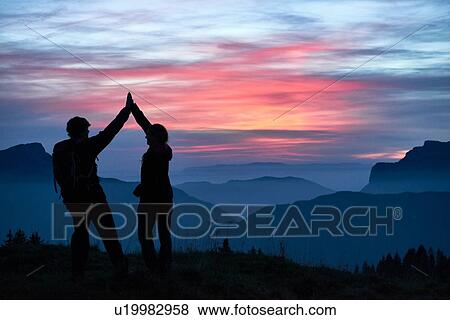 Hikers high fiving, Manigod, Rhone-Alpes, France View Large Photo Image Stock Photo - Hikers high fiving, Manigod, Rhone-Alpes, France. Fotosearch
