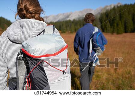 Picture - Hikers on grassy field, Manigod, Rhone-Alpes, France. Fotosearch
