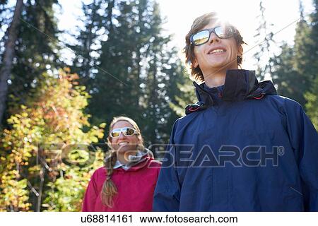 Stock Image - Hikers on sunny day's trek. Fotosearch