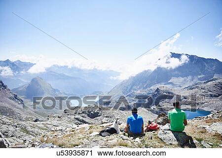 Stock Image - Hikers stopping for break, Mont Cervin, Matterhorn, Valais, Switzerland. Fotosearch