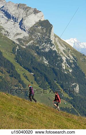 Hikers trekking on hillside, Manigod, Rhone-Alpes, France View Large Photo Image Stock Image - Hikers trekking on hillside, Manigod, Rhone-Alpes, France. Fotosearch