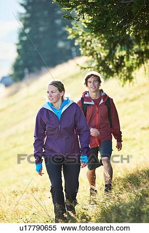 Stock Photography - Hikers trekking on hillside, Manigod, Rhone-Alpes, France. Fotosearch