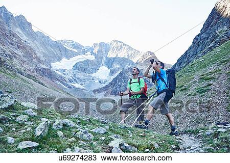 Stock Image - Hikers using binoculars, Mont Cervin, Matterhorn, Valais, Switzerland. Fotosearch