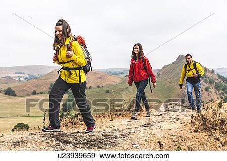 Stock Photo - Hikers walking on ridge, Chrome Hill, Peak District, Derbyshire. Fotosearch
