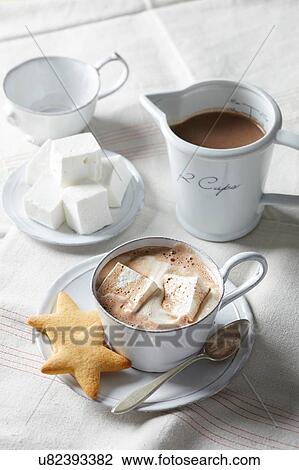 Stock Image - Hot chocolate with homemade marshmallows and star cookies. Fotosearch