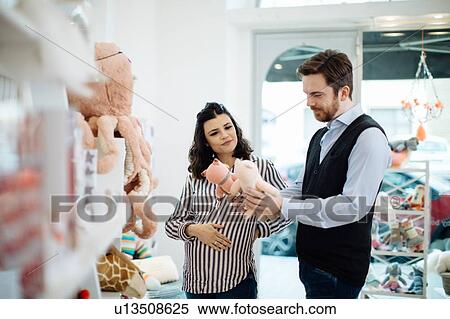 Husband and pregnant wife shopping for soft toys View Large Photo Image Stock Photography - Husband and pregnant wife shopping for soft toys. Fotosearch