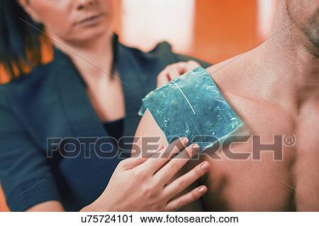 Ice pack on painful shoulder View Large Photo Image Stock Image - Ice pack on painful shoulder. Fotosearch