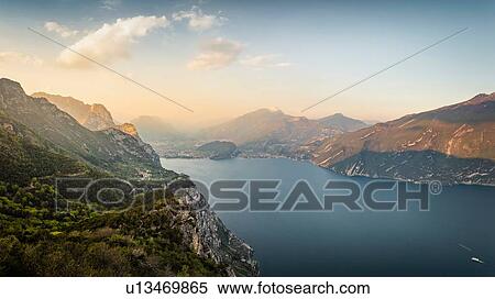 Stock Photography - Lake Garda at sunset. Shot from near mountain village Pregasina. View north onto Riva del Garda and Torbole, Lombardia, Italy. Fotosearch