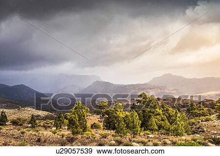 Stock Photo - Landscape with distant mountains and storm clouds, Mogan, Canary Islands, Spain. Fotosearch