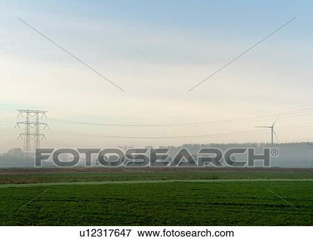 Landscape with wind turbine and power lines on a foggy morning, Netherlands View Large Photo Image Stock Photo - Landscape with wind turbine and power lines on a foggy morning, Netherlands. Fotosearch
