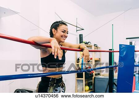 Laughing female boxer leaning over boxing ring ropes View Large Photo Image Stock Photograph - Laughing female boxer leaning over boxing ring ropes. Fotosearch