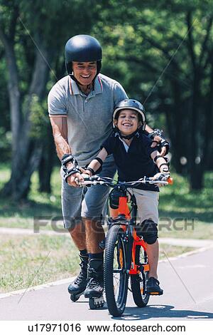 Learning how to ride a bicycle View Large Photo Image Stock Photograph - Learning how to ride a bicycle. Fotosearch