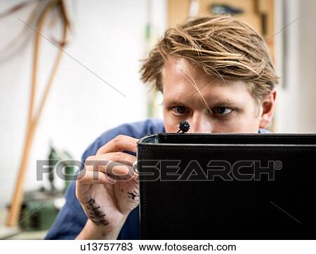 Leatherworker applying liquid glue to edge leather handbag in workshop View Large Photo Image Stock Image - Leatherworker applying liquid glue to edge leather handbag in workshop. Fotosearch