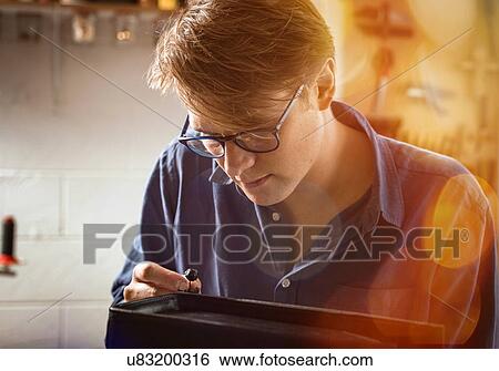 Leatherworker applying liquid glue to edge leather handbag in workshop, lens flare View Large Photo Image Stock Photograph - Leatherworker applying liquid glue to edge leather handbag in workshop, lens flare. Fotosearch