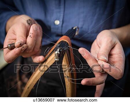 Leatherworker stitching handbag in workshop, close up of hands View Large Photo Image Stock Photo - Leatherworker stitching handbag in workshop, close up of hands. Fotosearch
