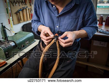 Leatherworker stitching leather in workshop, mid section View Large Photo Image Stock Image - Leatherworker stitching leather in workshop, mid section. Fotosearch