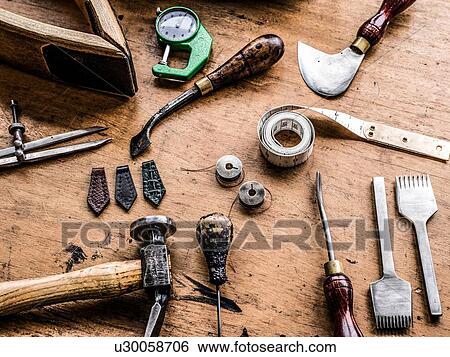 Leatherworker's workbench with hammer, tape measure and specialist tools, still life View Large Photo Image Stock Photograph - Leatherworker's workbench with hammer, tape measure and specialist tools, still life. Fotosearch