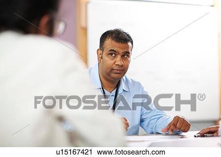 Lecturer talking to college students in classroom View Large Photo Image Stock Image - Lecturer talking to college students in classroom. Fotosearch